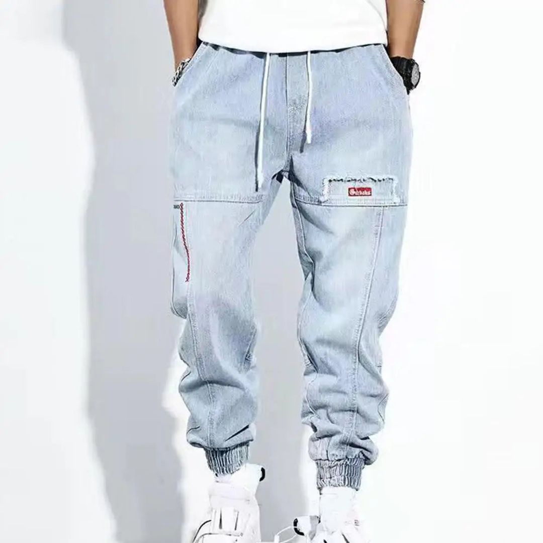 Men's denim jogger trousers in light blue, worn
