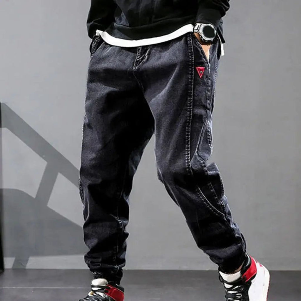 Men's denim jogger trousers in black, worn