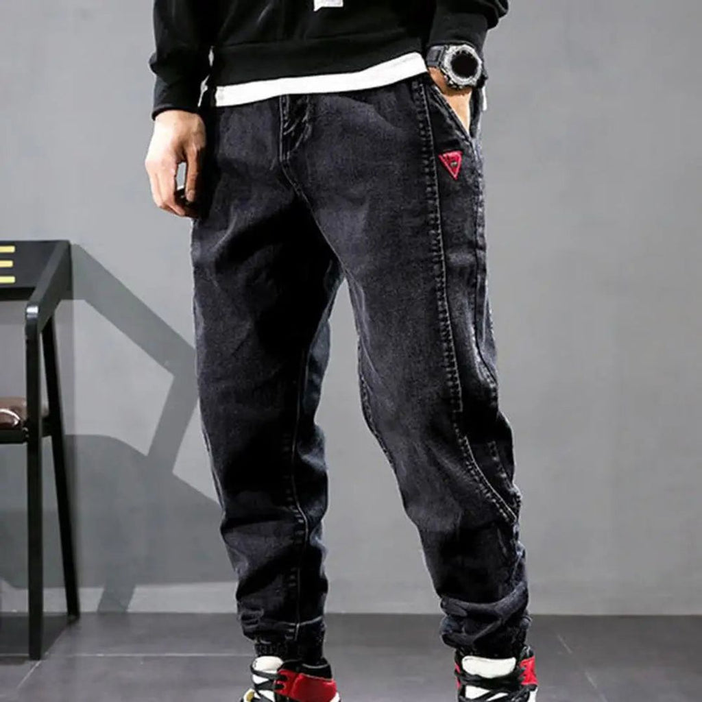 Men's denim jogger trousers in black, side view
