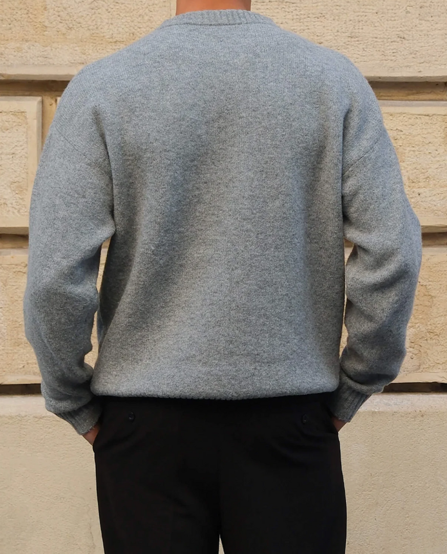 Man wearing the fine knit crew neck sweater in grey – back view