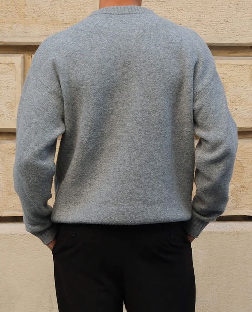 Man wearing the fine knit crew neck sweater in grey – back view