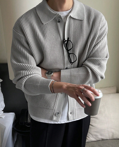 Man wearing the collared knit cardigan in grey – arms crossed