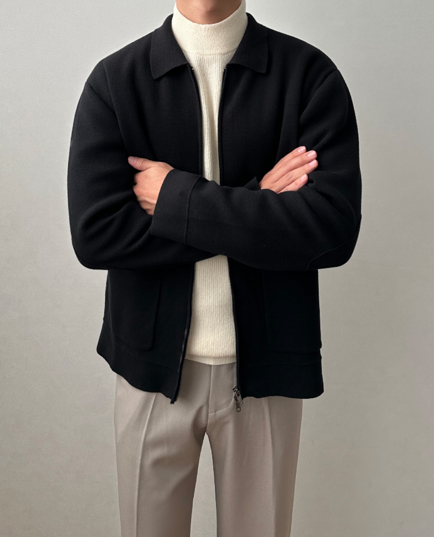 Man wearing the knit zip jacket in black – arms crossed