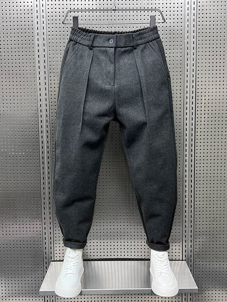 Men's pleated tapered trousers in grey – front view