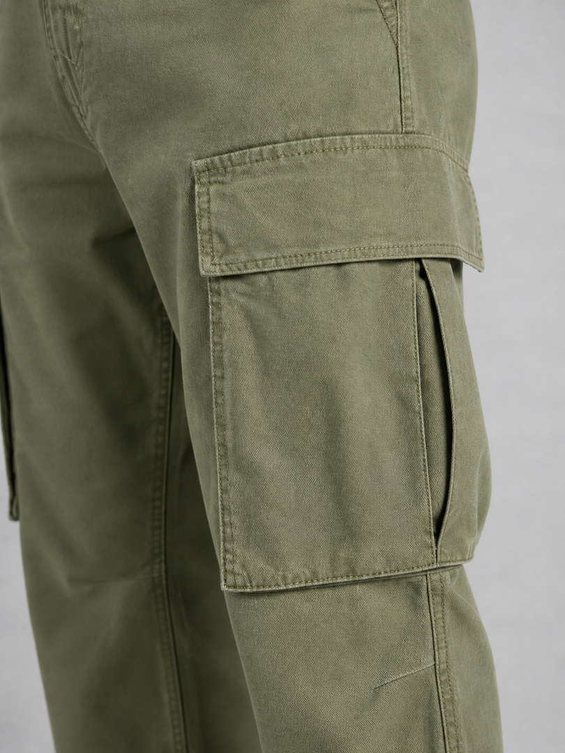 Close-up of the cargo pocket on the army green trousers