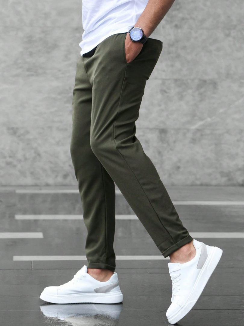 Man wearing the slim fit stretch trousers in army green – walking