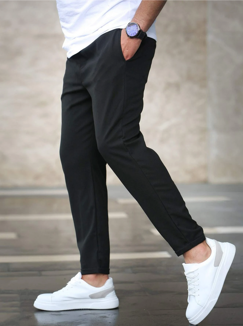 Man wearing the slim fit stretch trousers in black – walking