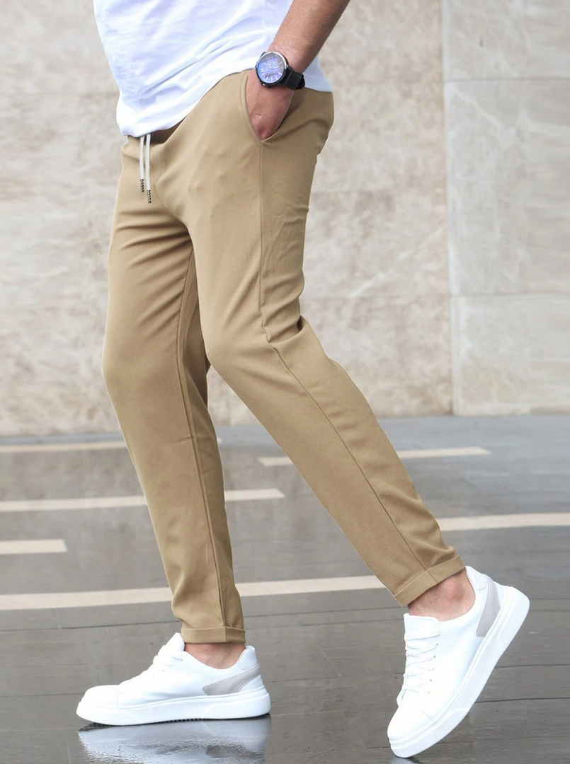 Man wearing the slim fit stretch trousers in beige – walking