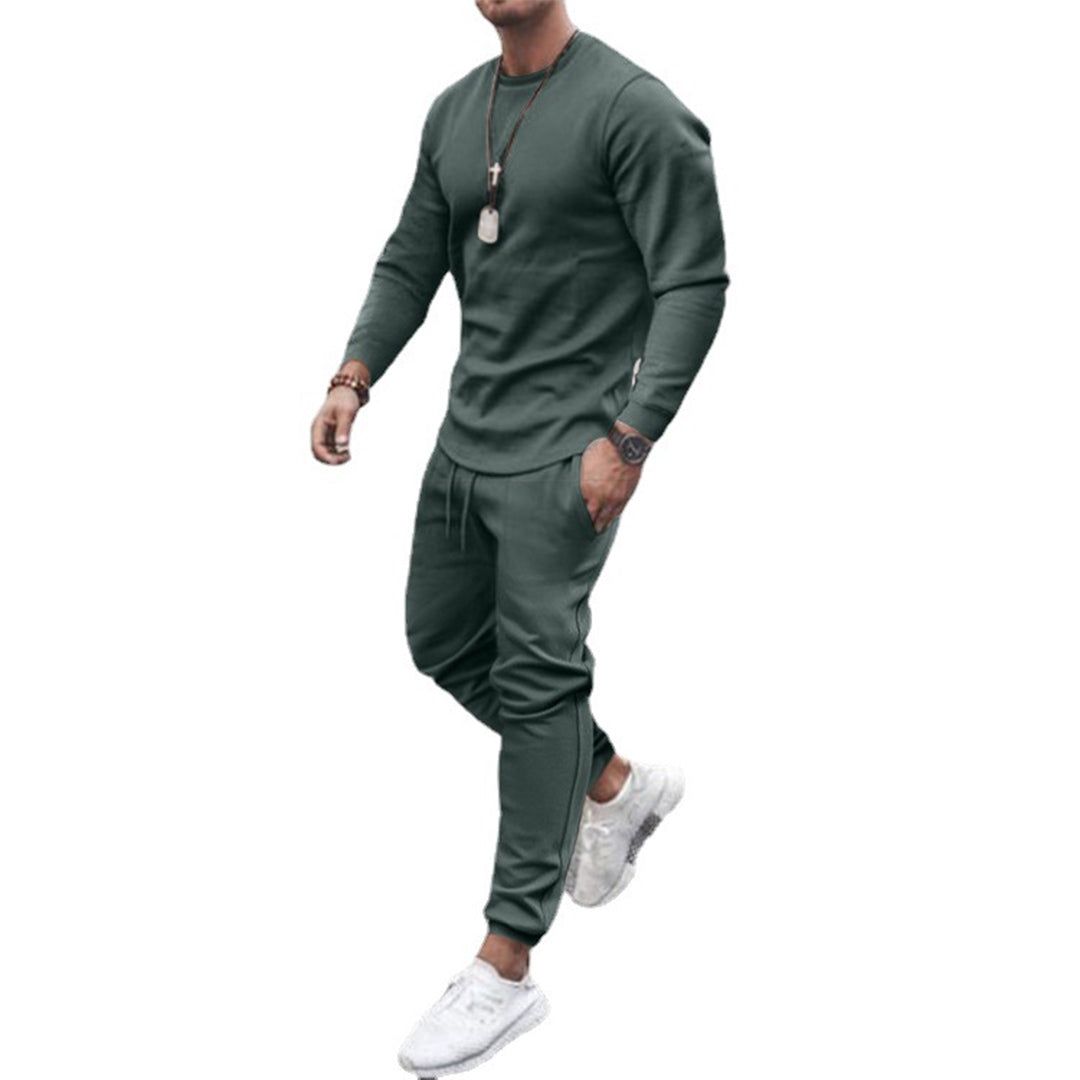 Men's slim fit sweatshirt and jogger set in green, studio view