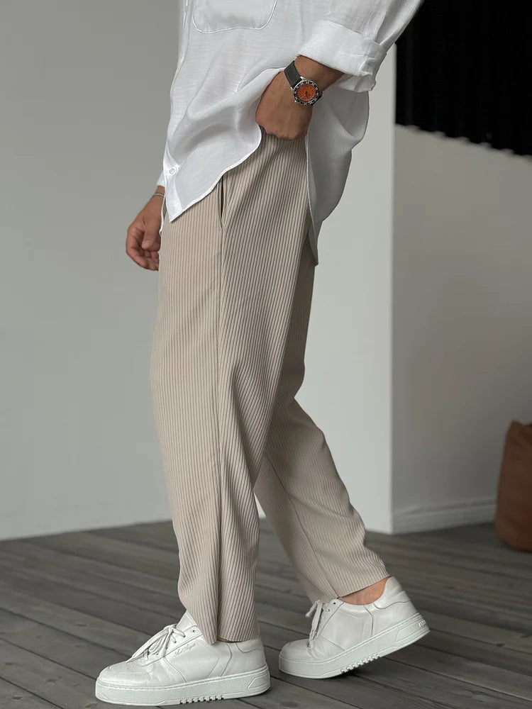 Man wearing the soft relaxed trousers in beige – walking