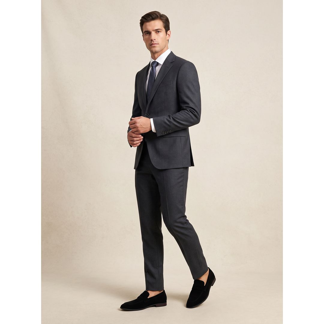 Men's suede-look penny loafers in black, worn with a suit