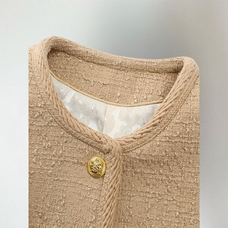 Close-up of the round neck and gold button