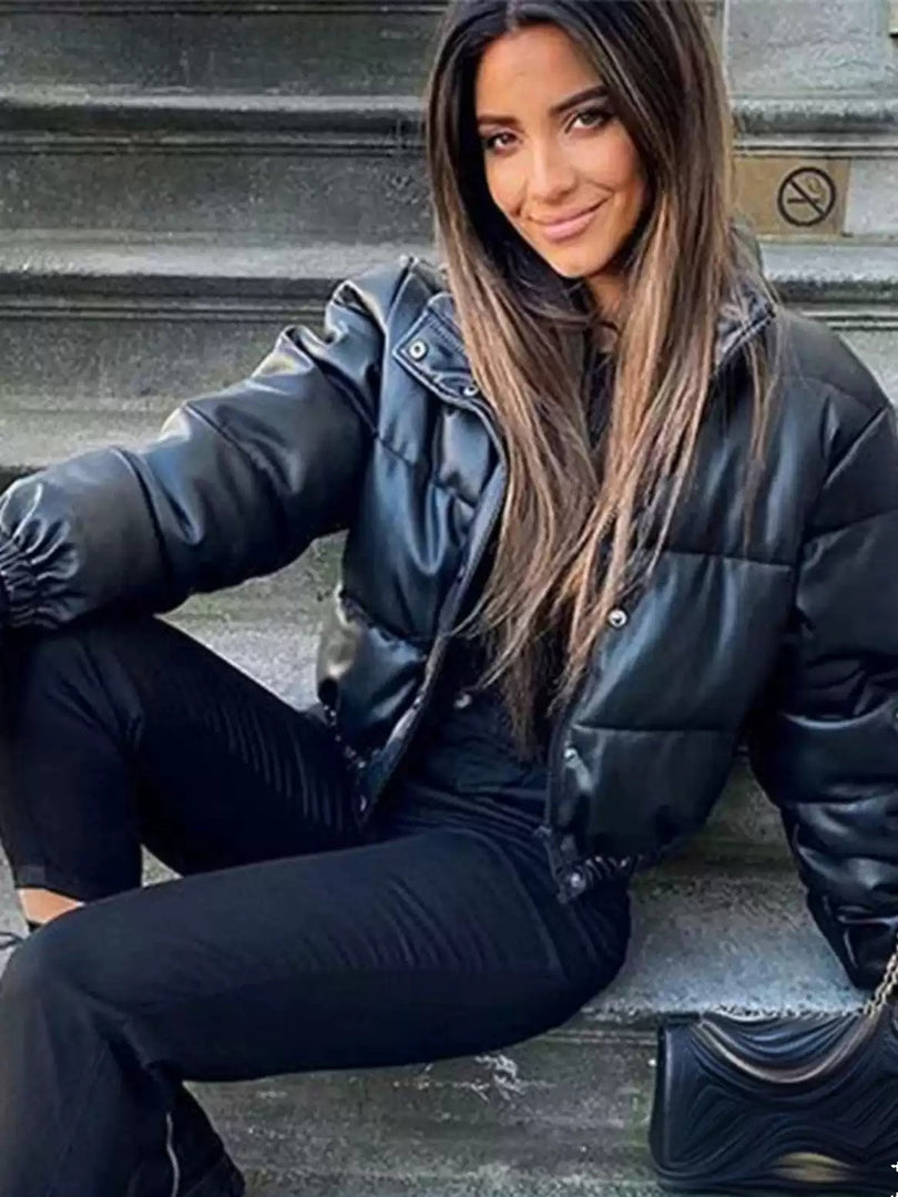Women's leather-look puffer jacket in black – seated