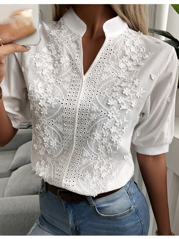 Women's white embroidered blouse – hands on hips