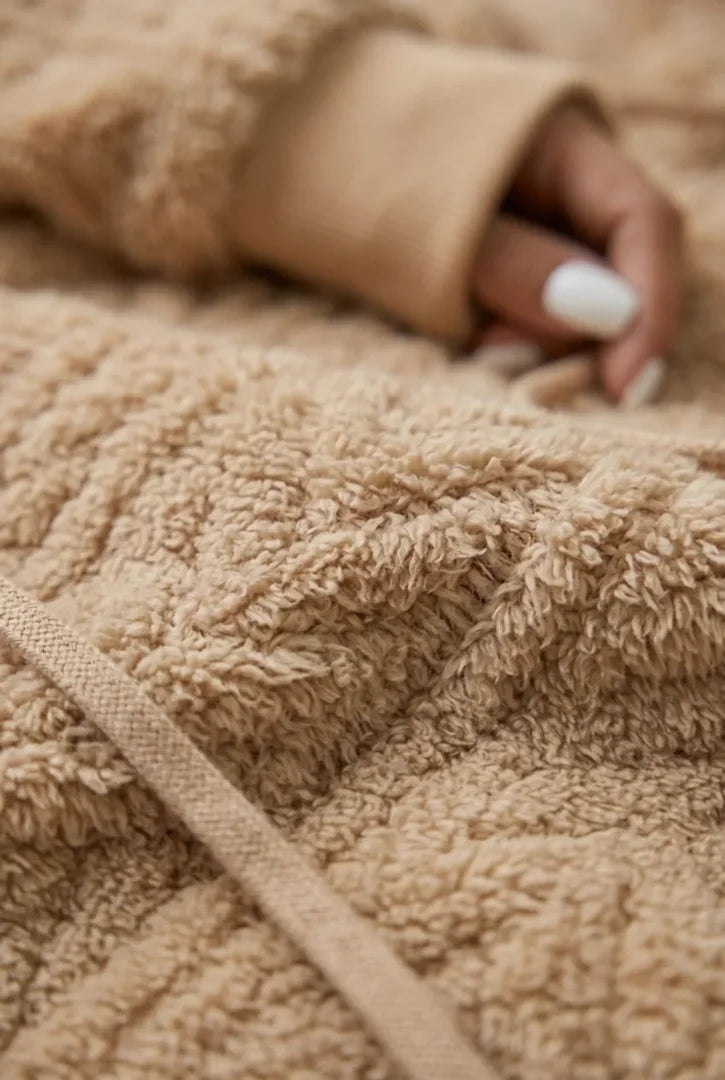 Close-up of the cable texture and drawstring