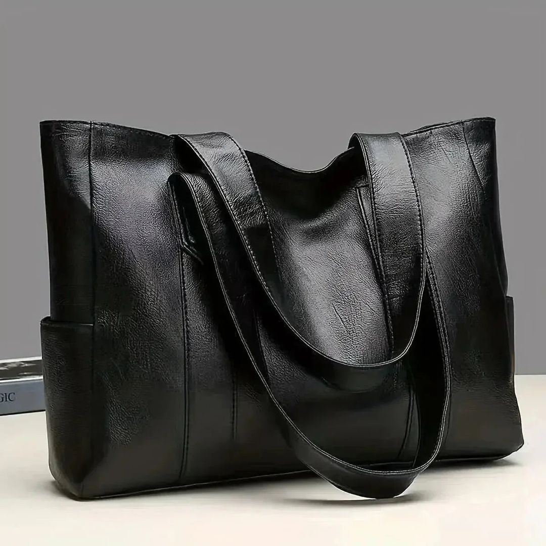 Women's large leather look tote bag in black, on a table