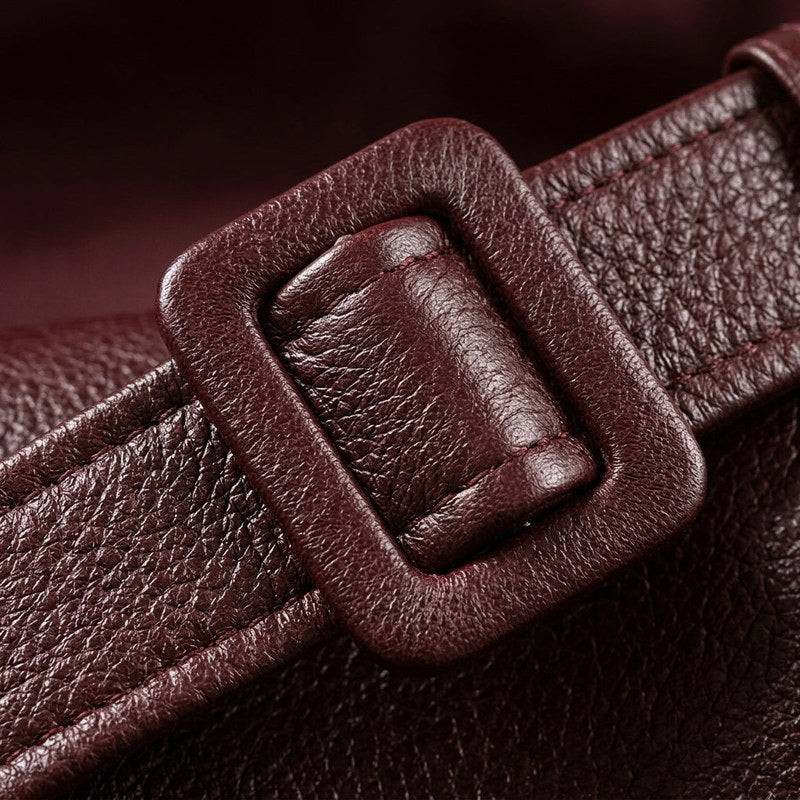 Women's leather look belted jacket in brown – close-up of the buckle
