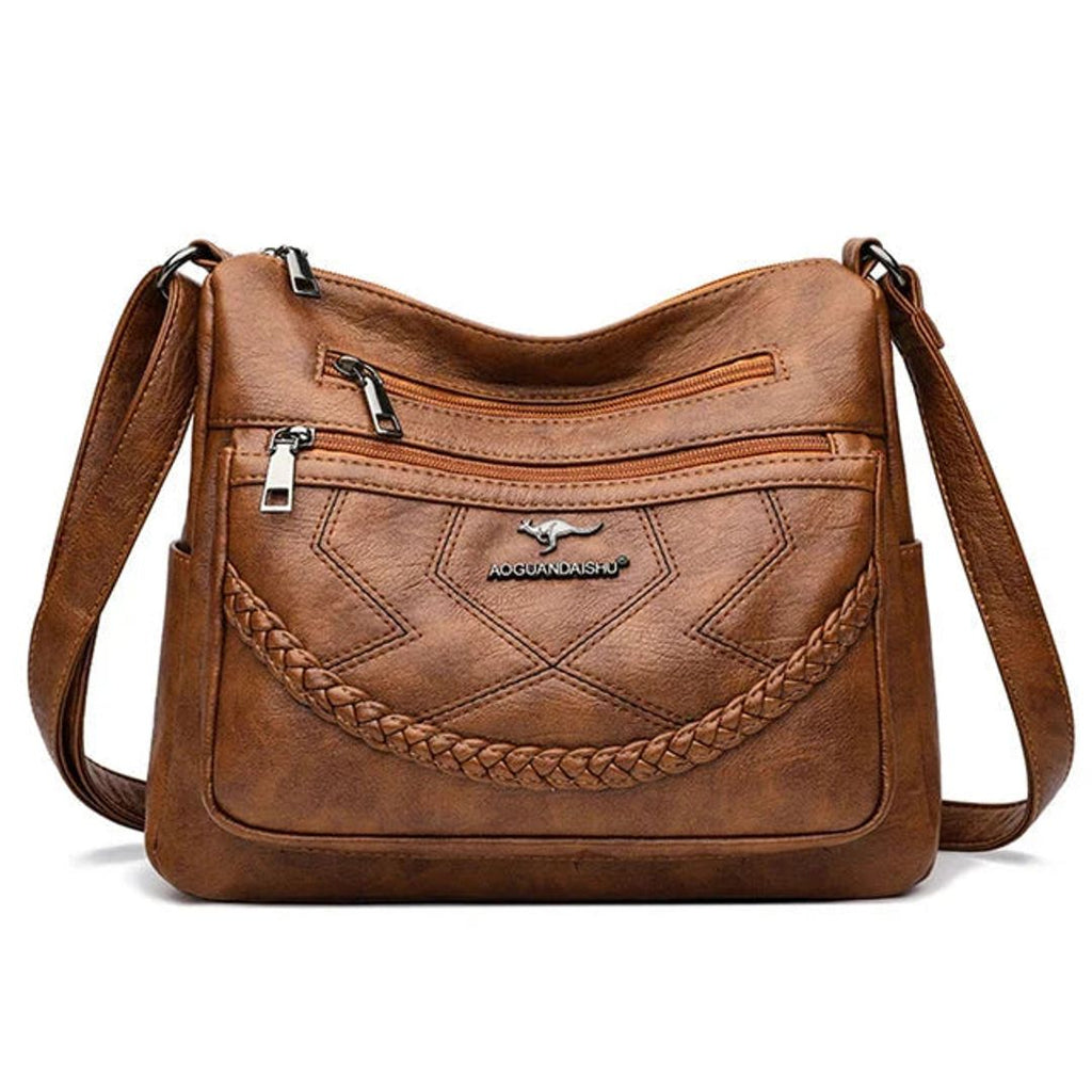 Women's leather look crossbody bag with zip pockets in tan