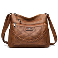 Women's leather look crossbody bag with zip pockets in tan