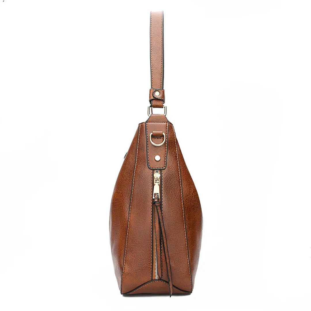 Women's leather look hobo bag with side zips in brown, side view
