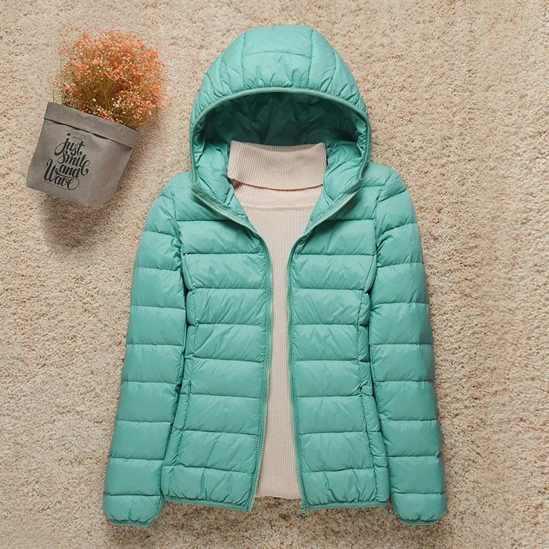 Women's lightweight hooded puffer jacket in turquoise – laid flat