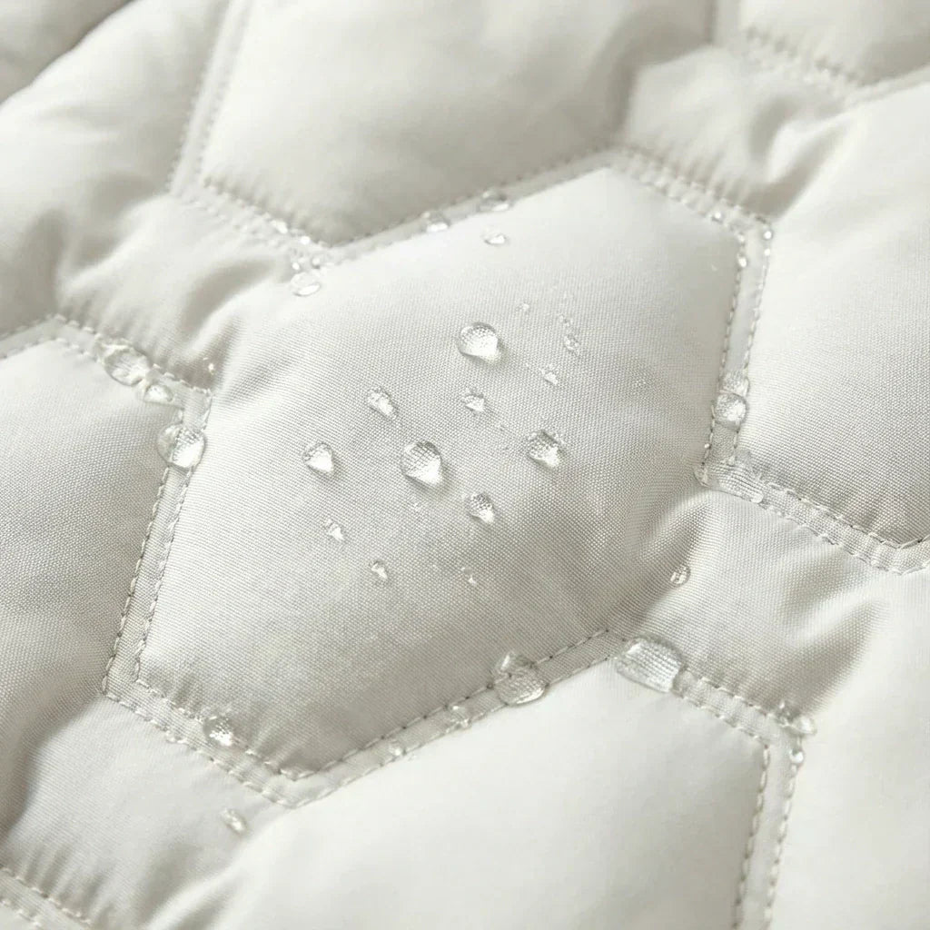 Close-up of the white quilting with water drops