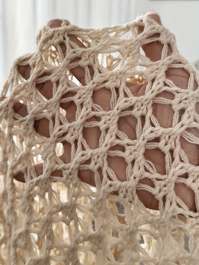 Close-up of the open knit on the beige draped cardigan