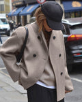 Women's oversized short double-breasted coat in taupe – worn with a cap