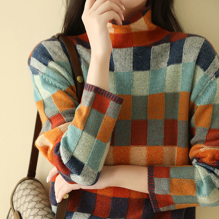 Women's patchwork check knit sweater worn with a shoulder bag