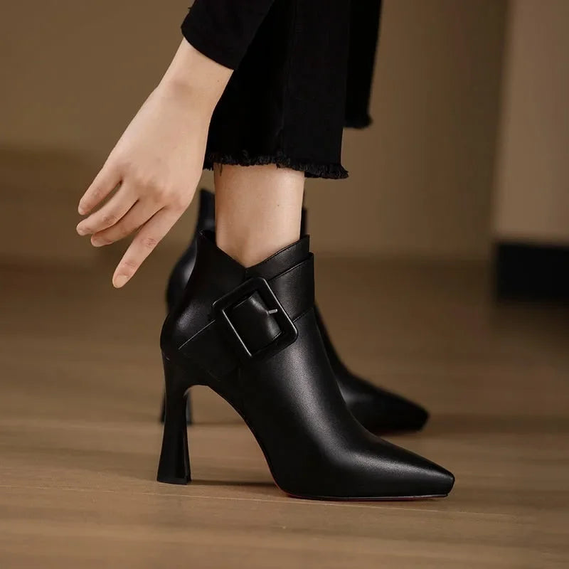 Women's pointed buckle heeled boots in black – worn