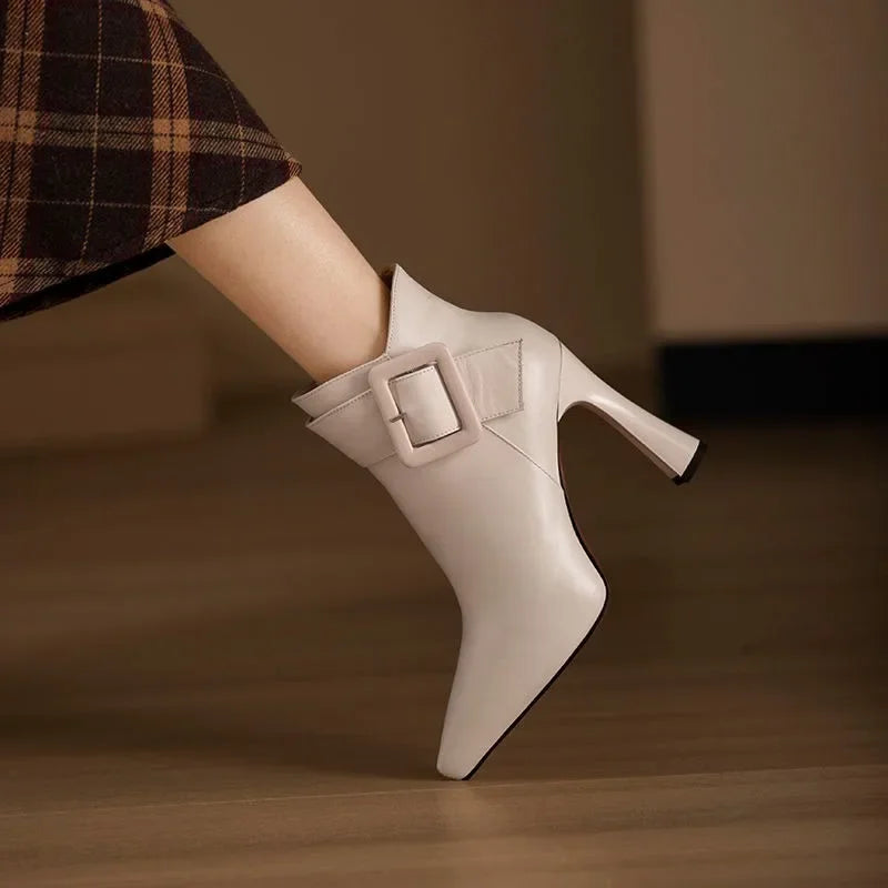 Women's pointed buckle heeled boots in beige – side view