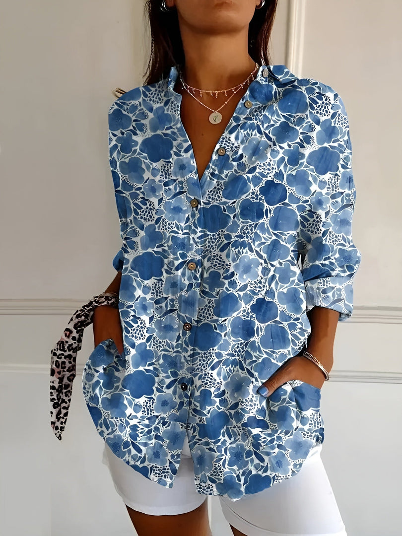 Women's printed button-up blouse in blue floral – close-up