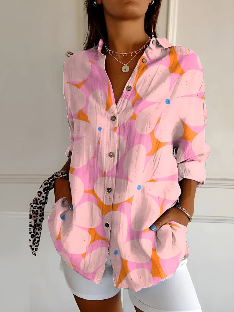 Women's printed button-up blouse in pink abstract – close-up