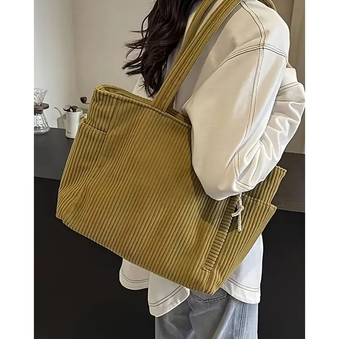 Women's ribbed tote bag with side pockets in mustard, on the shoulder