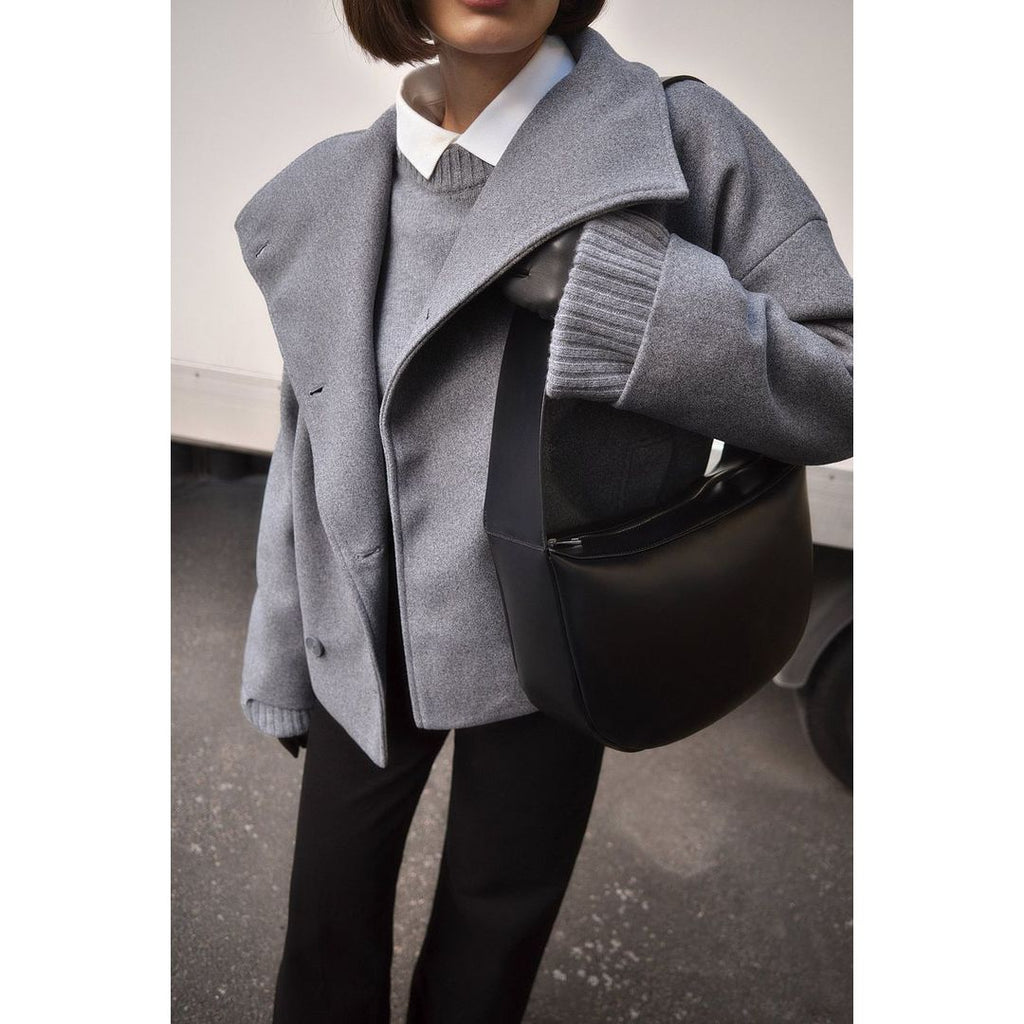 Women's short double-breasted coat with wide collar in grey, styled with a bag