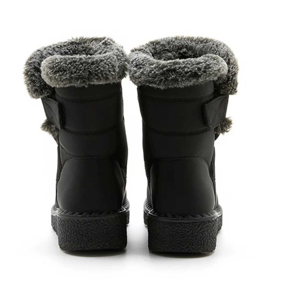 Women's faux fur cuff snow boots in black – back view