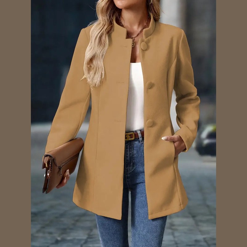 Women's stand collar coat in camel – side view with clutch