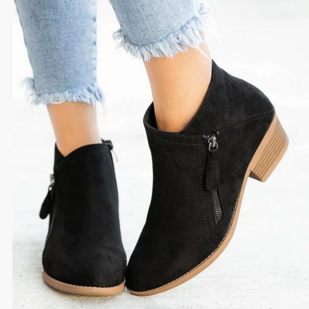 Women's side zip ankle boots in black – worn
