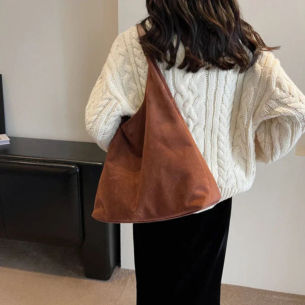 Women's suede look hobo bag in brown, worn on the shoulder