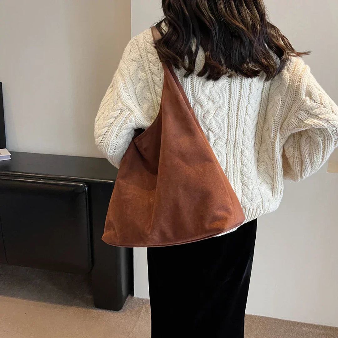 Women's suede look hobo bag in brown, worn on the shoulder