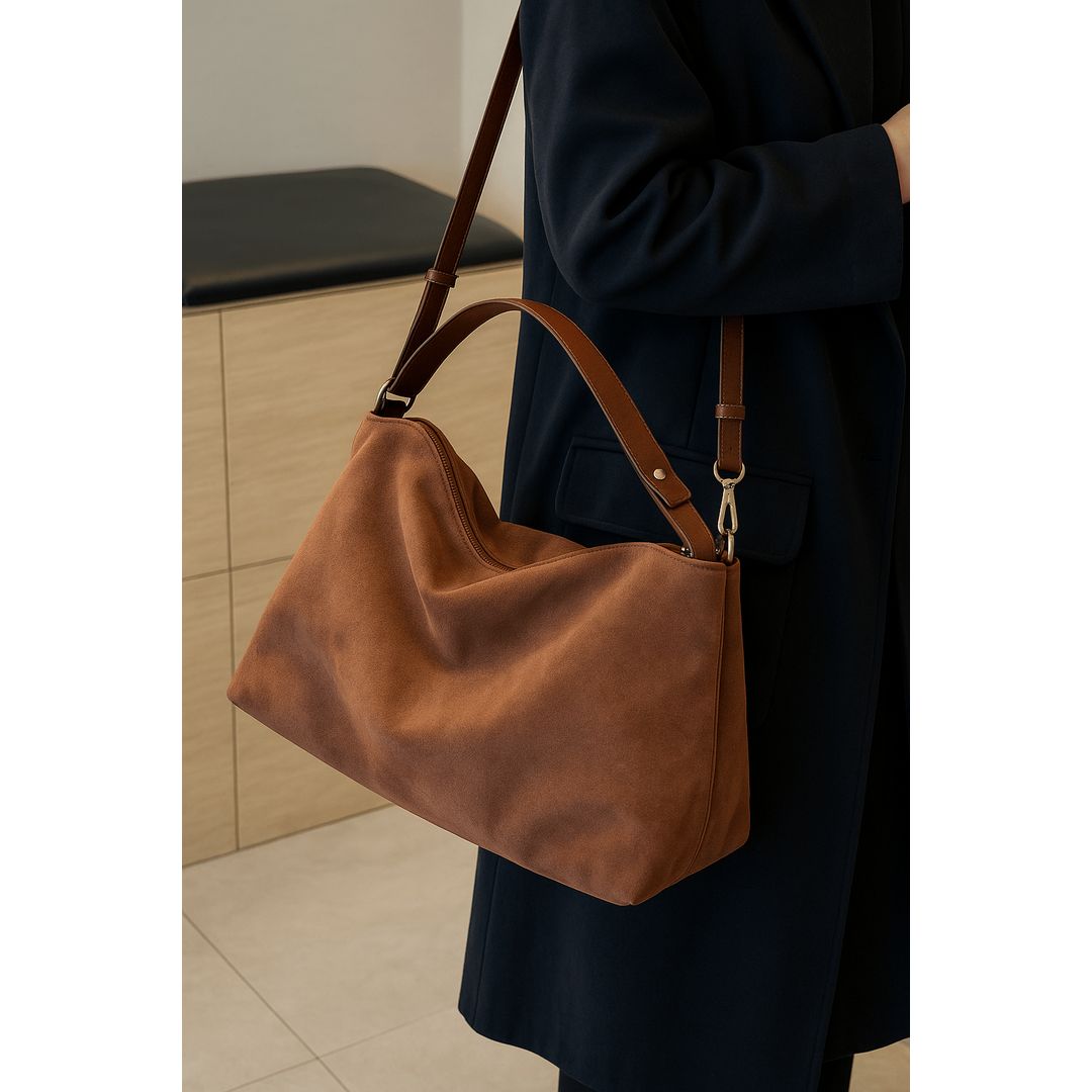 Women's suede look shoulder bag in tan, on the shoulder