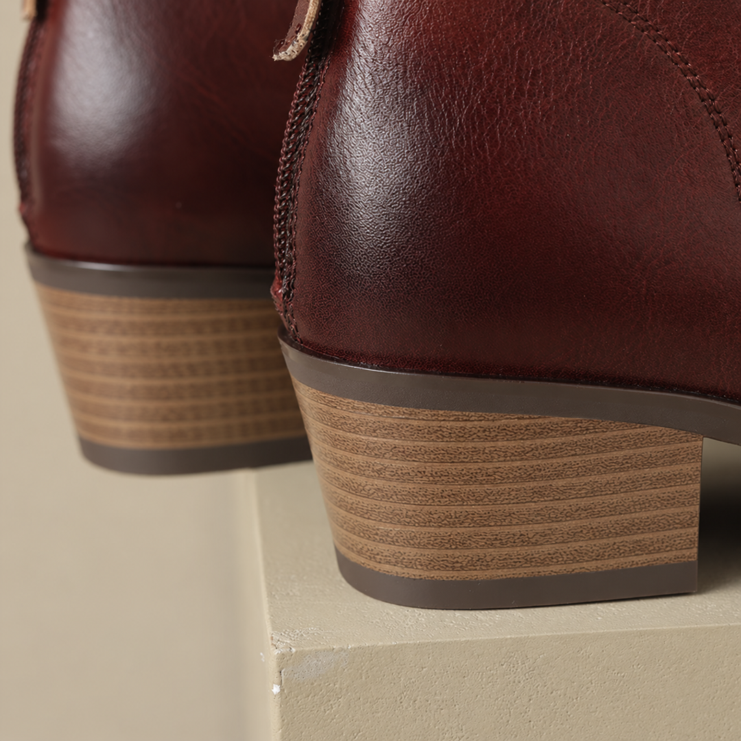 Close-up of the block heel on the brown V-cut ankle boots