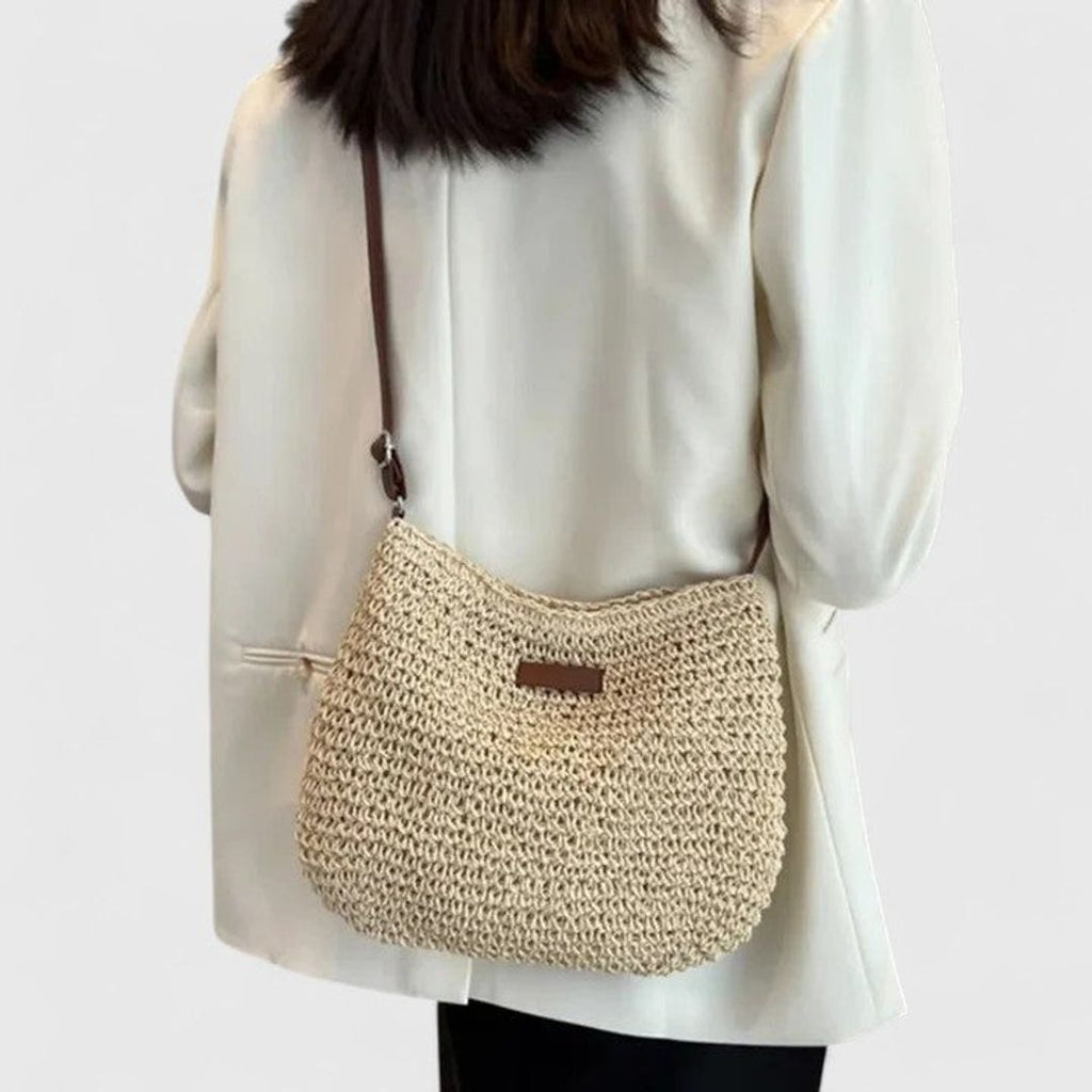 Women's woven half moon shoulder bag in natural, side view