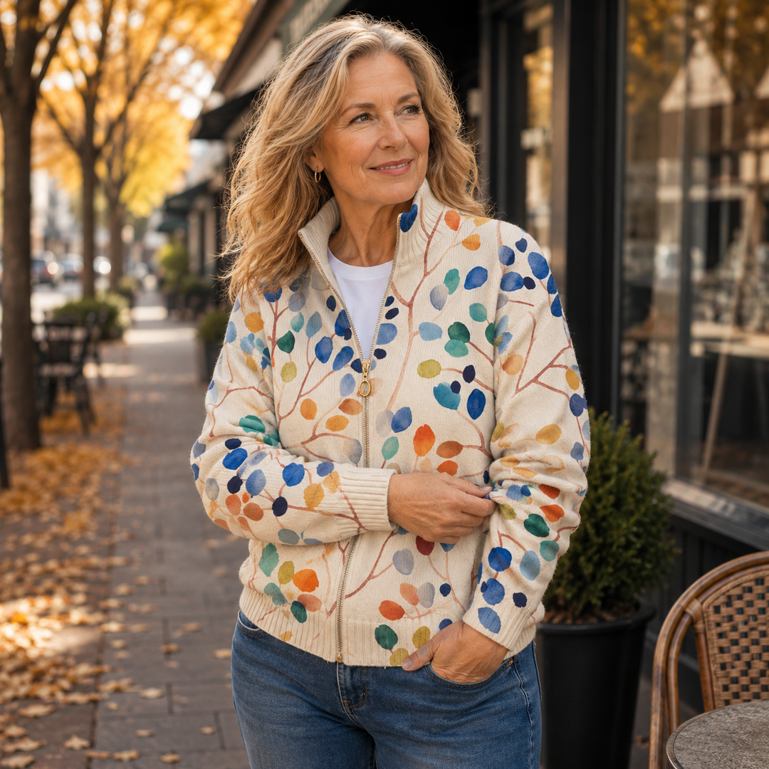 Woman wearing the leaf print zip cardigan outdoors in autumn